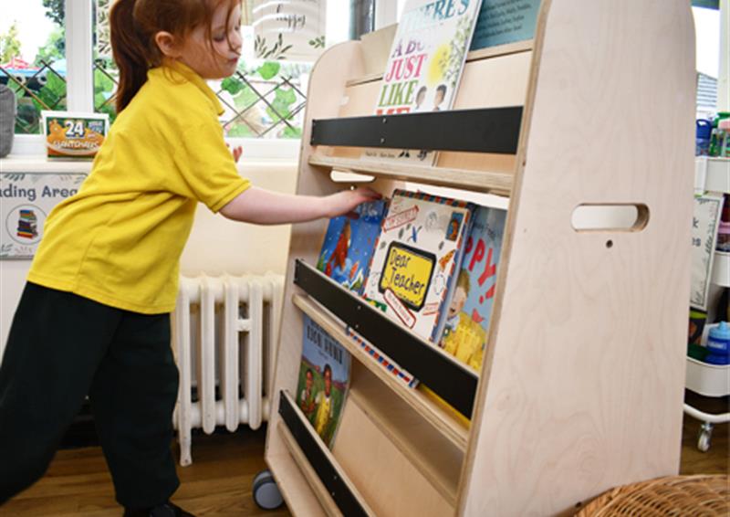 School child using Bookcase on Wheels